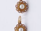 two pairs of pearl and gold earrings on a white surface