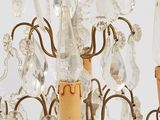 chandelier made of glass and brass with a candle holder