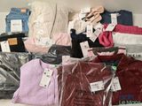 a lot of clothes that are on a shelf