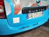a blue car with a sticker on the back of it