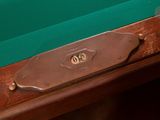 a close up of a pool table with a green cloth on it