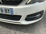 a white car parked on the side of the road