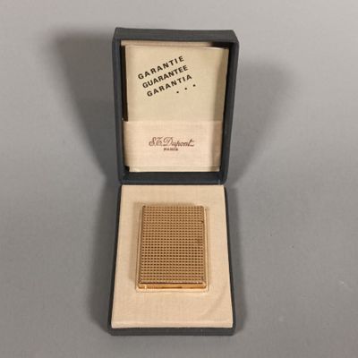 a gold plated cigarette case with a small cigarette in it
