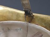 a gold purse with a black and white design on it