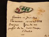 an old piece of paper with a small piece of jewelry on it