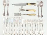many different types of silverware laid out on the table