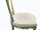 an image of a green chair with a white cushion on it