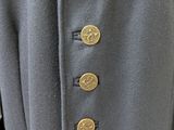 a close up of a military coat with buttons on it