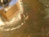 a close up of a metal object with a blue handle