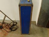 a small blue box sitting on the floor next to a chair