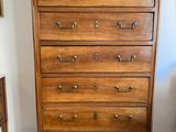a wooden chest of drawers in the corner of a room
