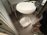 a person standing in a kitchen with a paper
