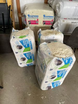 plusieurs rouleaux de papier toilette empilés les uns sur les autres dans un garage