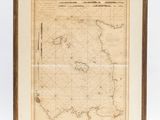 a framed map of the british isles, with a wooden frame