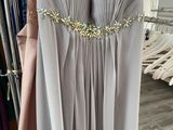 a dress hanging on a rack in a dress shop