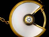 an image of a gold and white pendant with a diamond