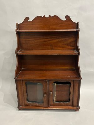 an antique wooden bookcase with two doors and two shelves