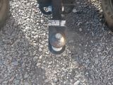 a close up view of a truck ' s front wheel and tire