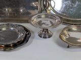 several pieces of silverware on a white table with a mirror