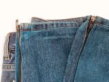 the back of a pair of jeans with a zipper in the pocket