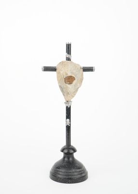 a close up of a cross with a skull on top of it