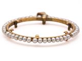 a close up of a bracelet with pearls on a white background