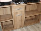 a wooden cabinet with a coffee maker on top of it