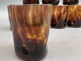 a close up of a glass with a lot of brown liquid in it