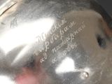 a silver vase with writing on it sitting on a table