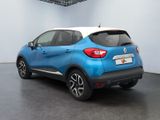 the rear of a blue and white car parked in a garage