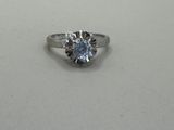 a picture of a diamond ring on a white surface