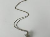 a silver necklace with a star charm hanging from it ' s side