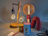 a lamp that is on a table next to a box and a lamp