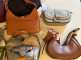 many different purses on a table in a store