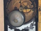 a clock that is sitting inside of a wooden box
