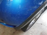 a close up of a car ' s bumper with a denting on it