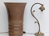a brown vase and a lamp on a white table