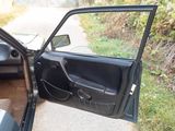 a black car with its door open on the side of the road