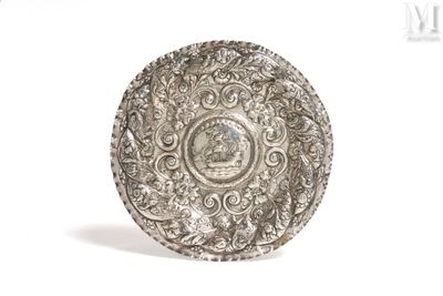 a silver plate with a picture on it on a white background