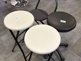 three stools that are sitting on a tile floor