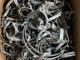 a cardboard box filled with lots of different types of clamps