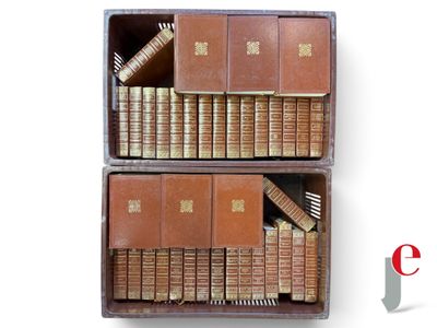 two wooden boxes with books in them on a white surface