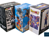 three boxes of dragon ball action figures sitting next to each other