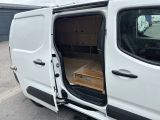 a white van with its doors open in a parking lot