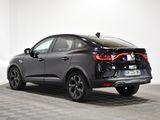 the rear end of a black car parked in a white room