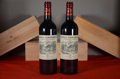 two bottles of red wine sitting next to each other on a table