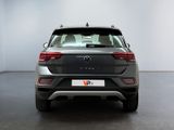 the rear end of a grey volkswagen suv parked in a room