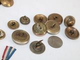 many different types of buttons and pins on a table