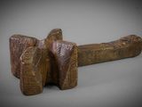an image of a wooden mallet on a gray background