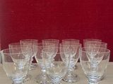 several empty wine glasses sitting on a table in front of a red wall